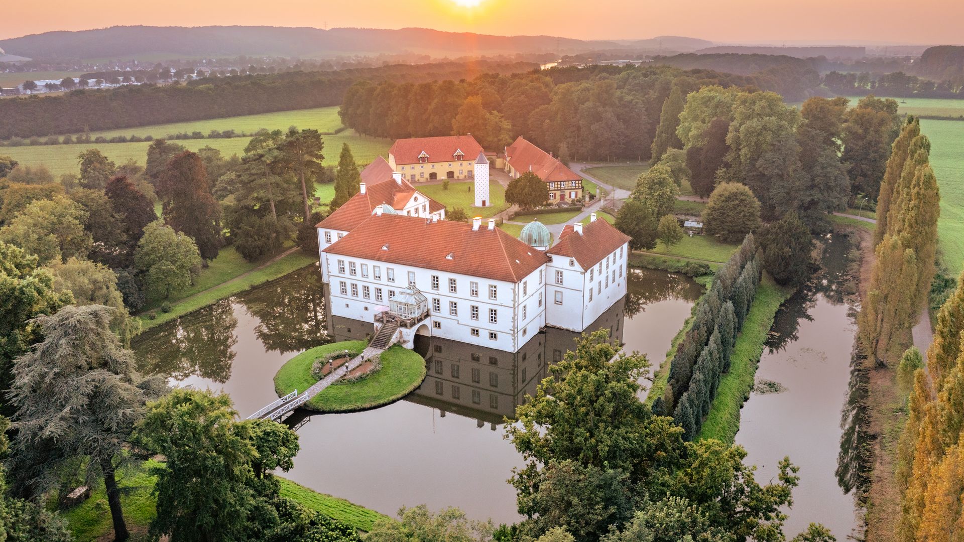 Historische Schlossanlage Schloss Hünnefeld mit Herrenhaus, Park und altem Baumbestand in ländlicher Umgebung.